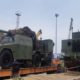 Nigerian military receives tanks, artillery from China. Nigeria’s military has taken delivery of VT-4 main battle tanks, SH-5 self-propelled howitzers and other equipment from China in an effort to strengthen its land forces in the battle against Boko Haram militants. The equipment was acquired from China’s Norinco after being ordered last year under an apparent $152 million contract. The equipment was unloaded on 8 April and included VT-4 main battle tanks, SH5 105 mm self-propelled artillery and other items. Nigerian Army Chief of Policy and Plans Lieutenant General Lamidi Adeosun said, “The process of acquiring this has been on for some time but thank God they are coming in now. From this, you can see how serious the Federal Government of Nigeria is in making sure that the Nigerian Army is not only equipped, but contains problem of insecurity we are having across the country. “This is being tackled with trained personnel and required equipment. What you are seeing here is just a tip of the iceberg. Others are still coming but it is very important that we all see that both the military and the government are really very serious to tackle the security problems across the nation.” Adeosun said the delivery from China includes main battle tanks, light tanks and two types of artillery. He added that personnel have been trained in China to operate the equipment. According to Nigerian media, 17 vehicles were offloaded on Wednesday, including VT-4 main battle tank and ST1 light tanks. Photos confirm VT-4 and SH-5 vehicles were delivered. In May 2019, Minister of Defence, Brigadier General Mansur Dan-Ali, said the Nigerian government had provided funding for the acquisition of modern equipment for the Nigerian armed forces, with some in service and others on the way. This included 35 main battle tanks, 25 Typhoon MRAPs (mine-resistant, ambush protected vehicles), 10 Spartan armoured personnel carriers, 20 Armoured Guard Booths, five armoured mine-clearing vehicles, 50 troop-carrying vehicles and 40 Buffalo vehicles, among others for the Nigerian Army. In addition, four Ships, 182 rigid hull inflatable and Epenal boats, four inshore patrol craft, two STAN Patrol Vessels and one helicopter were procured for the Nigerian Navy. The Nigerian Air Force has benefited from the acquisition of 25 fixed wing aircraft and 12 helicopters, Dan-Ali said at the time. The VT-4 (MBT-3000) main battle tank was built by Norinco for the export market and unveiled internationally in 2012. The 52-ton vehicle has a crew of three (commander, driver and gunner – an automatic loader reduces crew numbers). It is armed with a 125 mm smoothbore cannon, a remotely operated 12.7 mm anti-aircraft machine gun and a 7.62 mm coaxial machine gun but can also fire guided missiles. It can be fitted with a GL5 active protection system. The vehicle’s fire control unit also comprises roof-mounted panoramic sights, a laser warning device, and a digital gun control system designed to support day and night operation. A 1 200 hp turbocharged diesel engine gives a maximum speed of 70km/h and range of 500 km. The SH5 self-propelled artillery system is a development of Norinco’s SH2. It is armed with a 105 mm gun on a 6×6 platform. The gun has an elevation of zero to 70 degrees with traverse being 30 degrees left and right. Range of the weapon is around 18 km. The SH5 is fitted with a computerized fire-control system, including GPS navigation and positioning, targeting, and communications systems. The SH5 has an armoured crew compartment, which is protected again small arms fire and shell splinters. The vehicle has a top speed of 100 km/h and range of 800 km.