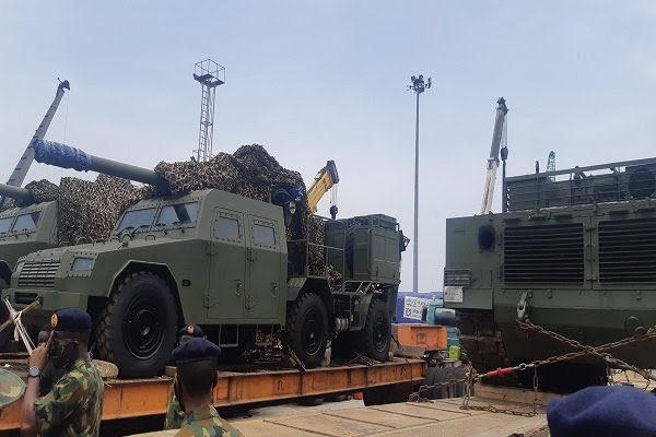 Nigerian military receives tanks, artillery from China. Nigeria’s military has taken delivery of VT-4 main battle tanks, SH-5 self-propelled howitzers and other equipment from China in an effort to strengthen its land forces in the battle against Boko Haram militants. The equipment was acquired from China’s Norinco after being ordered last year under an apparent $152 million contract. The equipment was unloaded on 8 April and included VT-4 main battle tanks, SH5 105 mm self-propelled artillery and other items. Nigerian Army Chief of Policy and Plans Lieutenant General Lamidi Adeosun said, “The process of acquiring this has been on for some time but thank God they are coming in now. From this, you can see how serious the Federal Government of Nigeria is in making sure that the Nigerian Army is not only equipped, but contains problem of insecurity we are having across the country. “This is being tackled with trained personnel and required equipment. What you are seeing here is just a tip of the iceberg. Others are still coming but it is very important that we all see that both the military and the government are really very serious to tackle the security problems across the nation.” Adeosun said the delivery from China includes main battle tanks, light tanks and two types of artillery. He added that personnel have been trained in China to operate the equipment. According to Nigerian media, 17 vehicles were offloaded on Wednesday, including VT-4 main battle tank and ST1 light tanks. Photos confirm VT-4 and SH-5 vehicles were delivered. In May 2019, Minister of Defence, Brigadier General Mansur Dan-Ali, said the Nigerian government had provided funding for the acquisition of modern equipment for the Nigerian armed forces, with some in service and others on the way. This included 35 main battle tanks, 25 Typhoon MRAPs (mine-resistant, ambush protected vehicles), 10 Spartan armoured personnel carriers, 20 Armoured Guard Booths, five armoured mine-clearing vehicles, 50 troop-carrying vehicles and 40 Buffalo vehicles, among others for the Nigerian Army. In addition, four Ships, 182 rigid hull inflatable and Epenal boats, four inshore patrol craft, two STAN Patrol Vessels and one helicopter were procured for the Nigerian Navy. The Nigerian Air Force has benefited from the acquisition of 25 fixed wing aircraft and 12 helicopters, Dan-Ali said at the time. The VT-4 (MBT-3000) main battle tank was built by Norinco for the export market and unveiled internationally in 2012. The 52-ton vehicle has a crew of three (commander, driver and gunner – an automatic loader reduces crew numbers). It is armed with a 125 mm smoothbore cannon, a remotely operated 12.7 mm anti-aircraft machine gun and a 7.62 mm coaxial machine gun but can also fire guided missiles. It can be fitted with a GL5 active protection system. The vehicle’s fire control unit also comprises roof-mounted panoramic sights, a laser warning device, and a digital gun control system designed to support day and night operation. A 1 200 hp turbocharged diesel engine gives a maximum speed of 70km/h and range of 500 km. The SH5 self-propelled artillery system is a development of Norinco’s SH2. It is armed with a 105 mm gun on a 6×6 platform. The gun has an elevation of zero to 70 degrees with traverse being 30 degrees left and right. Range of the weapon is around 18 km. The SH5 is fitted with a computerized fire-control system, including GPS navigation and positioning, targeting, and communications systems. The SH5 has an armoured crew compartment, which is protected again small arms fire and shell splinters. The vehicle has a top speed of 100 km/h and range of 800 km.