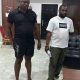 $87m Theft: Abayomi Remanded As Court Adjourn Till October The Federal High Court sitting in Abuja on Monday, July 24th, 2023 has adjourned the arraignment of Abayomi OluwaSesan and Onifade Adeniyi who were charged by the Inspector General of Police, Kayode Egbetokun, for gaining access to millions of subscribers’ investments at the Afriq Arbitrage Company online trading platform to October 9th, 2023. They were accused of stealing, diverting and converting the sum of $87,883,904 (N75b based on black market rate) USD to personal use. In the charge sheet with Suit No: FHC/ABJ/CR/289, the IGP’s lawyer, Wisdom Madaki charged the duo and others now at large on 10 counts bordering on cybercrime, money laundering and advanced fee fraud, allegedly perpetrated against the trading platform. The police alleged they were able to commit the offence by fraudulently changing the ownership credentials of the Company’s Chief Executive Officer, Jesam Michael, among other things. When the matter was called up before Justice Binta Nyako, the suspects lawyer raised the objection that they have obtained an injunction to contest the issue of their human right. The honorable judge rhetorically asked him if the case is in Lagos why is he in the court room today? The issue at the federal high court is not a human right issue but a criminal issue which supercede the so called objection raised by the suspects lawyer. The honorable judge reminded him that he is not helping matter but that since that's what's he preferred, he should go to Algis court and sort our the issues first and come back to her court to continue the criminal case. She, however reminded him that the court won't be in session till October. Thus, she adjourned the case till October 9th, 2023. It would be recalled that Abayomi Segun Oluwasesan, who was employed by his boss on the 15th of June, 2022 to work as a web developer, literally tempered with the platform at a time when his boss, Jesam Micheal went for a liver transplant and entrusted the codes to him. Overwhelmed by greed, Abayomi who was entrusted with the sensitive data for the smooth operations of the company, engaged the services of his cohorts, disrupting the smooth operations of the platform and stealing hard-earned investors' money running into several billions. Checks revealed that AAS is a global phenomenon with over 100,000 investors from over 75 counties. Thinking his employer, Jesam Micheal would not survive the operation, he withdrew several millions of dollars and became an instant rich dude with an astonishing flamboyant lifestyle overnight. His first criminal act was obtaining a Ghania passport which he used in acquiring other international residency and properties. He became the owner of a car dealership known as FIDORAY Autos and imported over 30 exotic wonders on wheels. He acquired Tanzanian and Dubai citizenship. Aside from that, he bought state-of-the-art properties in the UK, Dubai, Tanzania, and Nigeria. One of the plazas he acquired in Lagos was to the tune of N450m, landed properties around Dangote refineries to the tune of N1b, and splashed a billion naira on the interior decoration of the Mesh 3-star hotel in Mainland, Lagos State. A nobody Abayomi was travelling across the globe with investors' money on first-class tickets. His dubious activities literally crashed the lucrative platform on the 15th of May, 2023.
